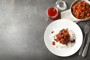 Chili con carne served with rice on table