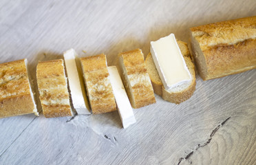Long crispy baguette with slices of brie cheese.