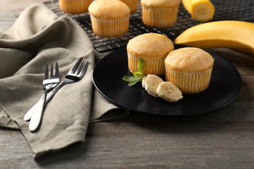Plate with banana muffins on table