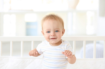 Fototapeta premium Cute little baby in crib at home