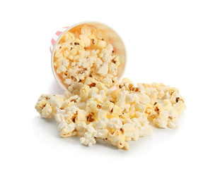 Paper cup and popcorn on white background