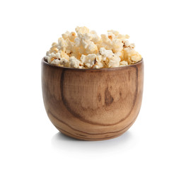 Wooden bowl with popcorn on white background