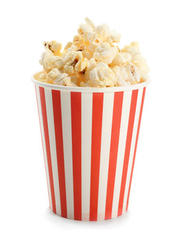 Paper cup with popcorn on white background