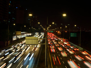 A view of The Gangbyeon Expressway, the road of Seoul at night. The roundabout 8 lane roads are full of cars.