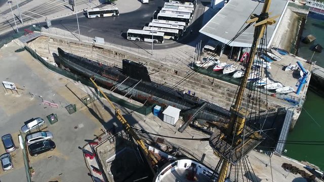 Aerial bird-eye view of submarine in empty dry dock used for construction
