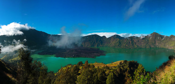 Colorful panorama view of the crater in Rinjani mount in Lombok, Indonesia on a nice sunny day and blue sky