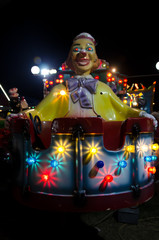 Fototapeta na wymiar clown at amusement park by night 