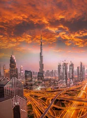 Rolgordijnen Dubai against colorful sunset with modern futuristic architecture , United Arab Emirates © Tomas Marek