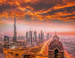 Fototapeta premium Dubai against colorful sunset with modern futuristic architecture , United Arab Emirates