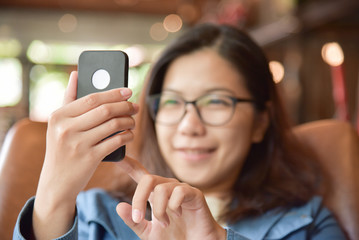 Woman in blue shirt taking selfies photo.