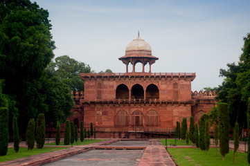 Sand stone building with arched doorways and a dome situated in a beautiful garden. The beauty and perfection is typical of mughal architecture. Many such buildings are part of the Taj Mahal complex