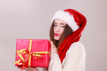 Woman holding gift box. Christmas time