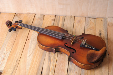 Fototapeta na wymiar one violin image .old brown stringed wooden instrument isolated on the wood background