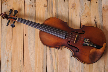 Obraz na płótnie Canvas one violin image .old brown stringed wooden instrument isolated on the wood background