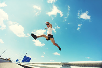 Young man jumping - fitness, sport, parkour, people concept 