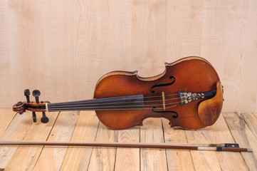 Fototapeta na wymiar one violin image .old brown stringed wooden instrument isolated on the wood background and bow