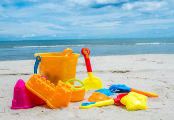 Fototapeta na wymiar Summer time and kids toys on tropical sand beach