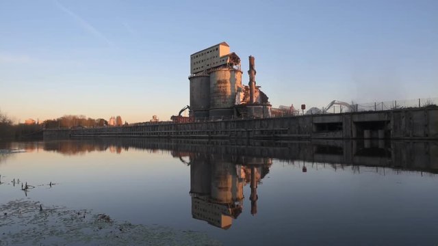 Industrial soda ash plant at dusk in the process of demolition with water reflection. Brunner Mond, Winnington, Northwich, Cheshire UK.