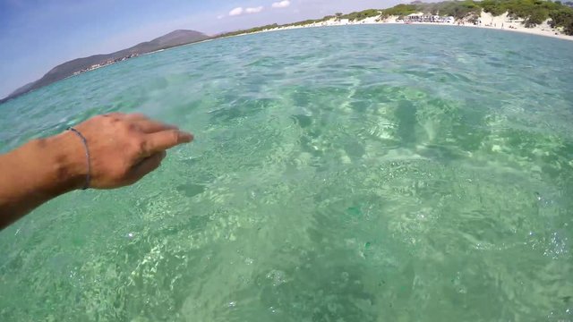 Man swimming in Sardinia turquoise sea, Italy