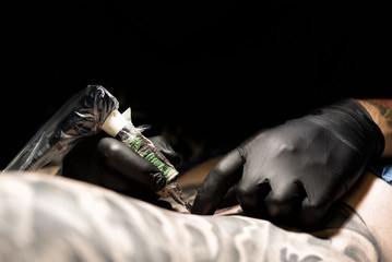 Tattoo artist at work. Closeup