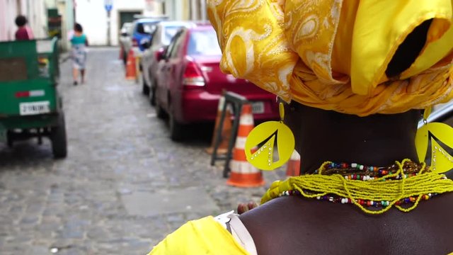 Brazilian woman of African descent - Baiana walking in Salvador Streets, Brazil