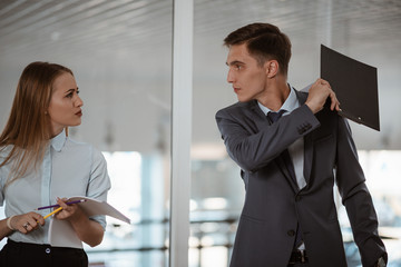 Assault at company/ Guy and the girl office employees in business clothes are arguing. The man...
