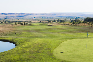 Mountain landscape on the horizon behind the golf course.