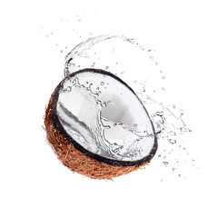 Half of coconut and water splash on white background