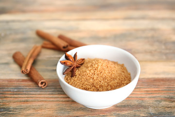 Bowl with cinnamon sugar on wooden table