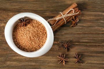 Bowl with cinnamon sugar on wooden table