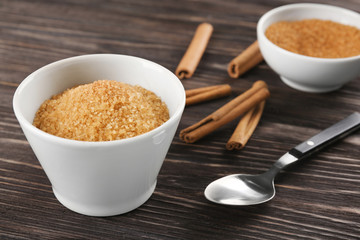 Bowl with cinnamon sugar on wooden table