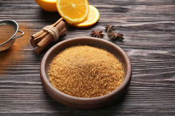 Plate with cinnamon sugar on wooden table