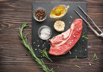 Fresh raw meat and spices on slate plate