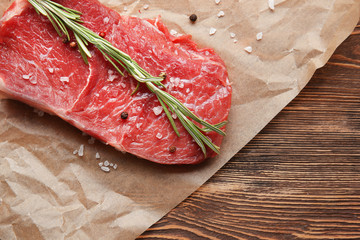 Fresh raw meat with spice on parchment paper
