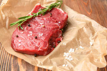 Fresh raw meat with spice on parchment paper