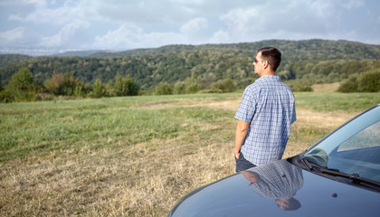 Road trip break after long drive. man enjoys sunset.