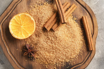 Beautiful composition with sweet cinnamon sugar on wooden board