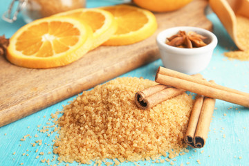 Pile of sweet cinnamon sugar on color wooden table