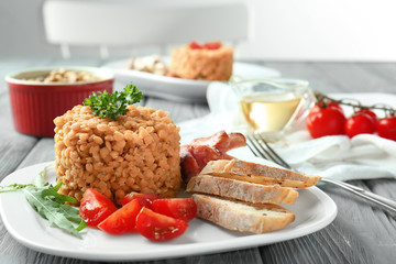 Plate with tasty lentils and sausages on table