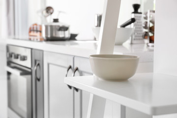 Fototapeta na wymiar Bowl on shelf in modern kitchen