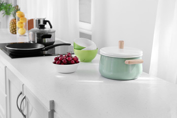 Cookware on table in modern kitchen