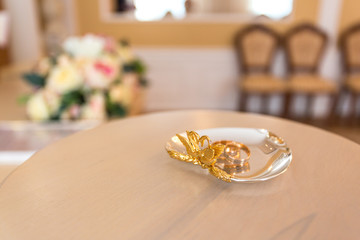 Gold wedding rings on the stand for rings