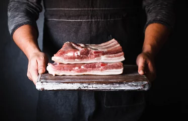 Gartenposter Pork belly Farm fresh Pork Belly butcher person curring bacon porchetta © casanisa