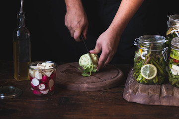 Green Kohlrabi bulbs hands cut kohlbari bulbs preparing vegetable preserving or canning food concept 