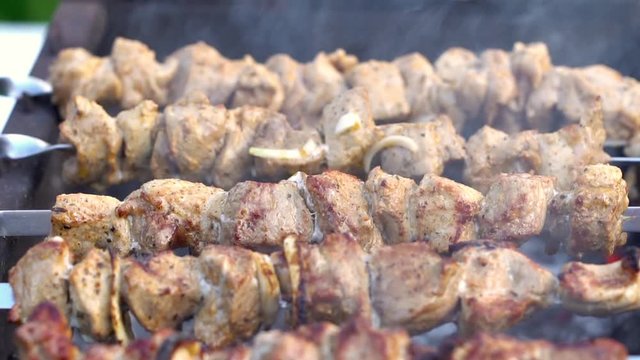 Grilling pork kebab on skewers at bbq, cooking process