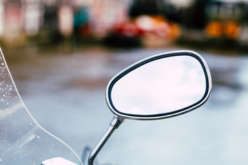 Close-up of a rear view mirror of a motor scooter © Edalin