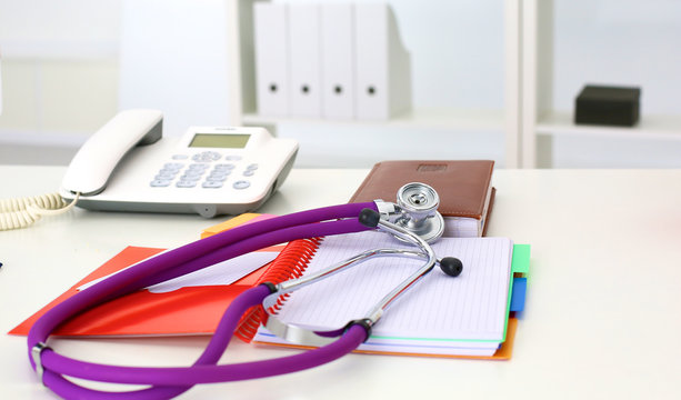 Medical stethoscope and a plate on the table