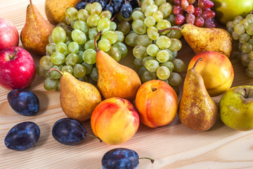 autumnal fruit still life on rustic wooden table background