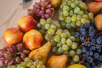 autumnal fruit still life on rustic wooden table background