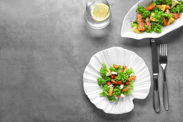 Plate of delicious salad with salmon on table